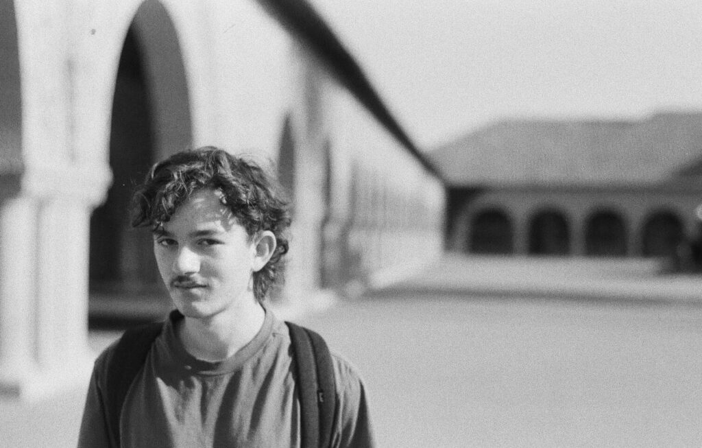 Warren poses for a photo on the campus of Stanford University.