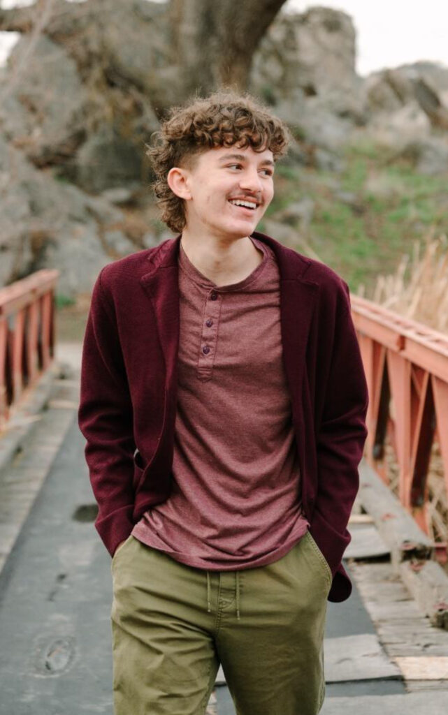 Warren poses for a photo on a bridge.