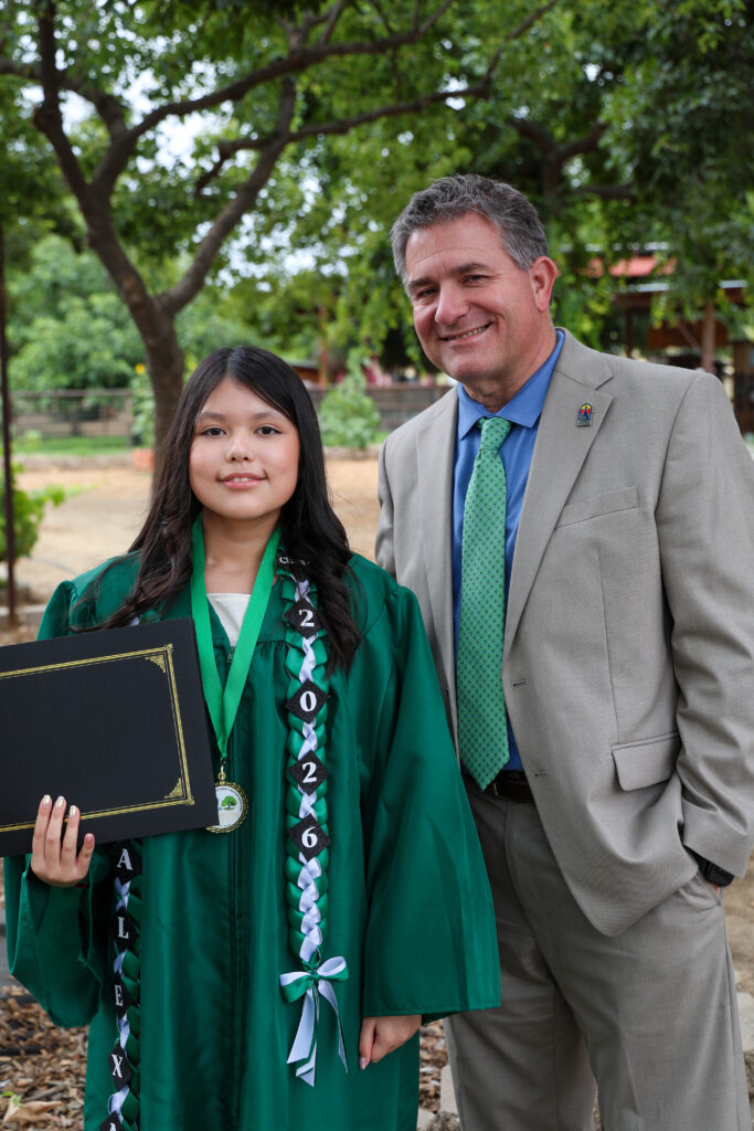 Dr. Mendiburu poses with 8th grader Alexa Rios.