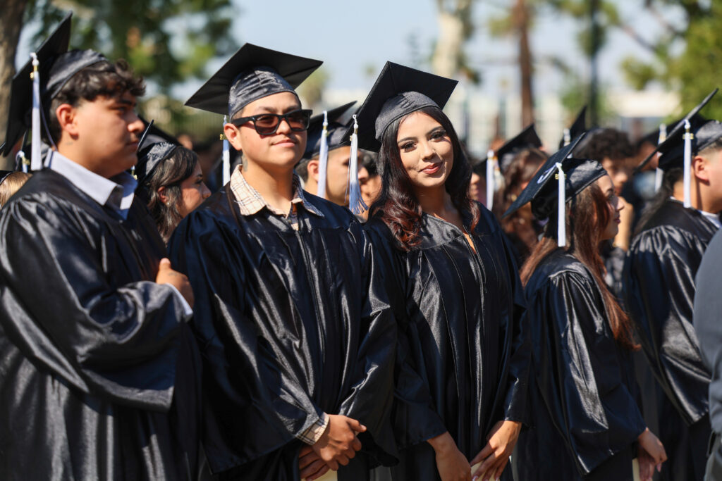 Graduates pose for a photo. 