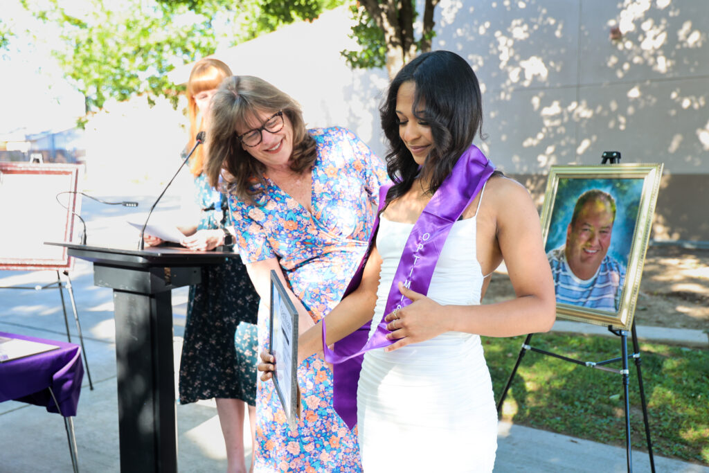 Jazzmine Saenz Williams is presented her award from KCSOS Assistant Superintendent Desiree Von Flue. 