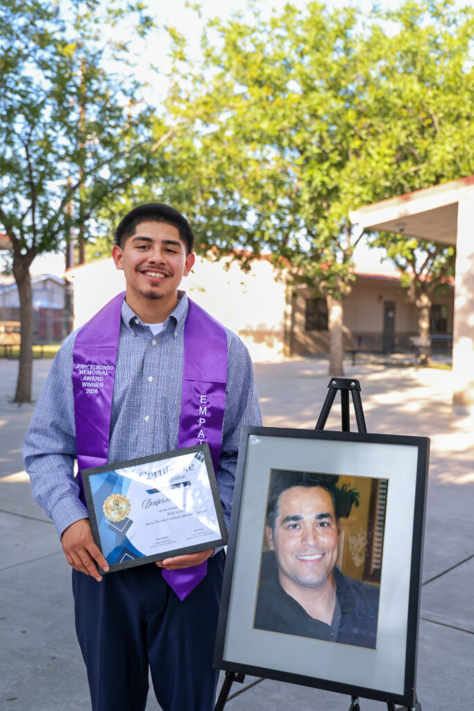 Ben proudly poses with his award alongside a photo of late KCSOS Jerry Elizondo.