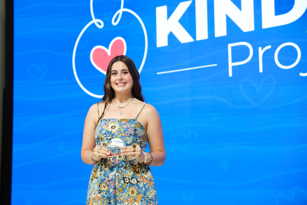 A student shows off her award.