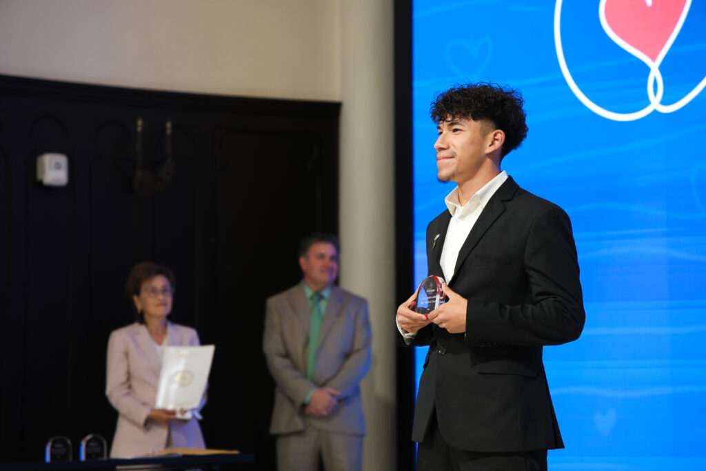 A student shows off his award.