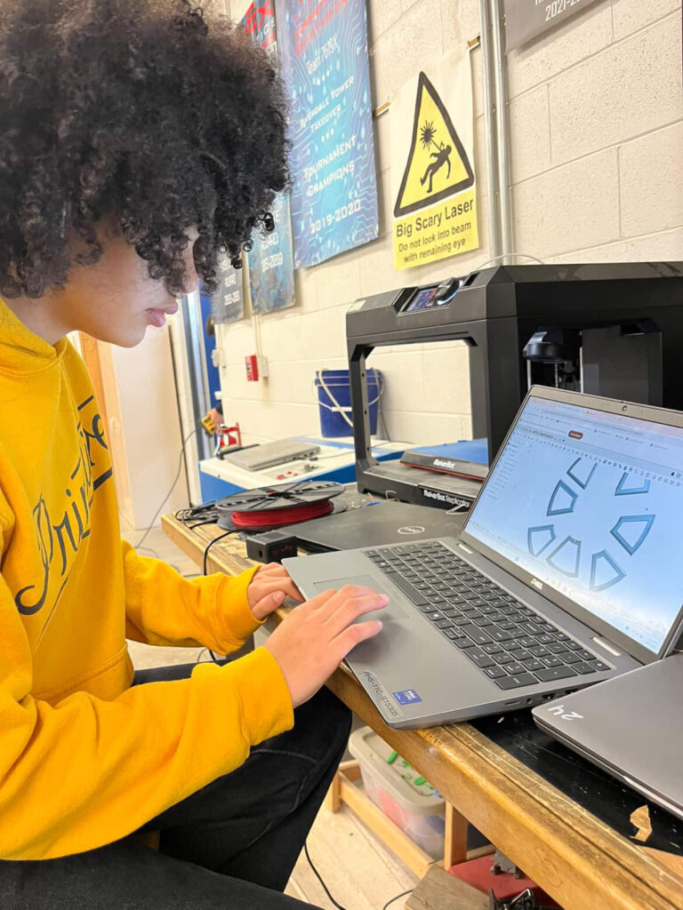 Wright working on a school project on a laptop.