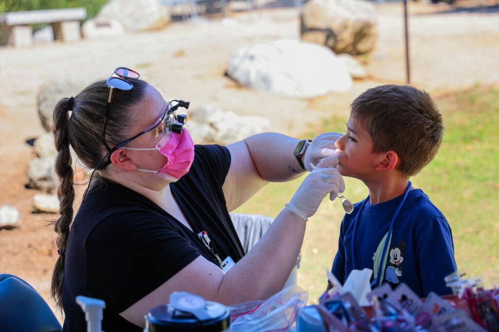 A child getting his tooth examined.