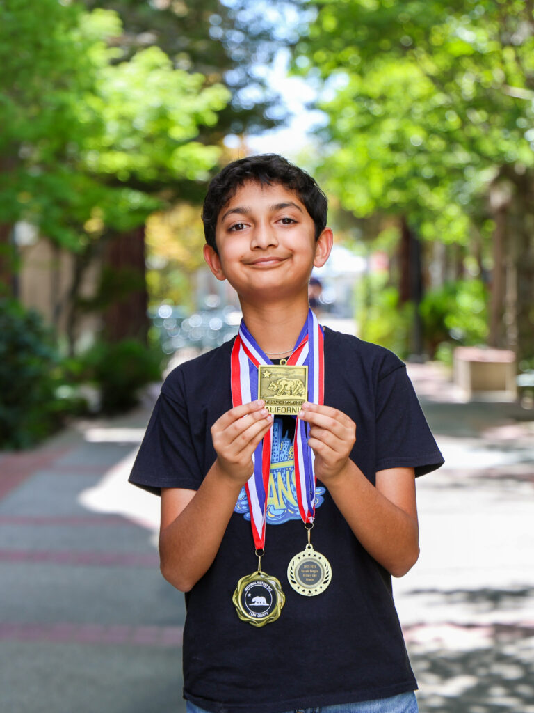 Jain wearing all three History Day competition medals.