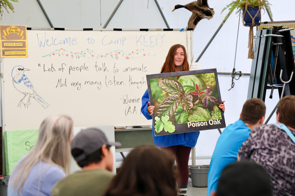 Naturalist holding picture of poison oak plant prior to hiking.