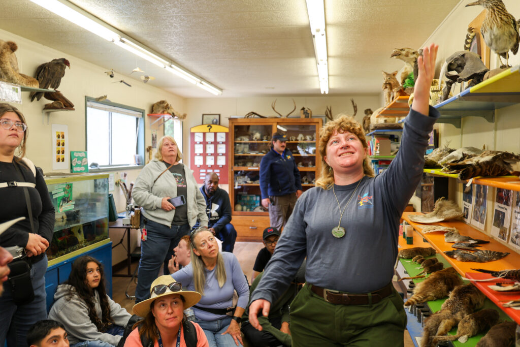 Naturalist showing students the objects in the Discovery Room.