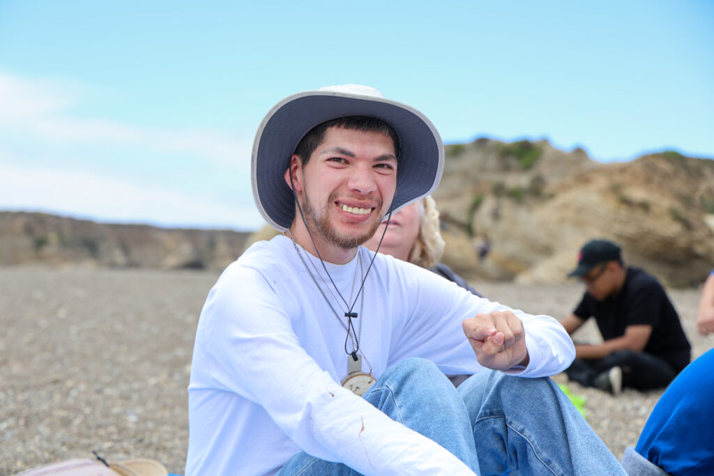 Student smiling at the beach.