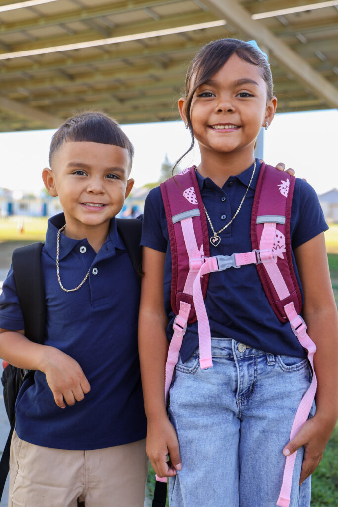 Photo of brother and sister on the first day of school.