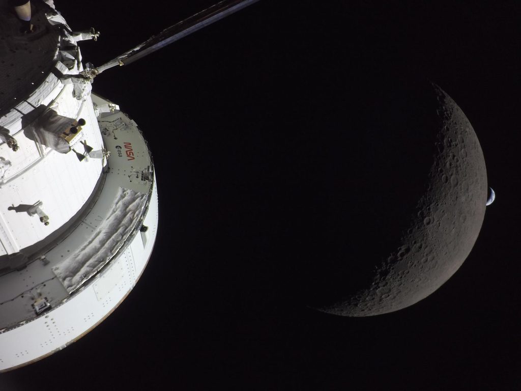 Photo provided by NASA from the Artemis II mission featuring the space craft during its lunar fly by with earth in the distance.
