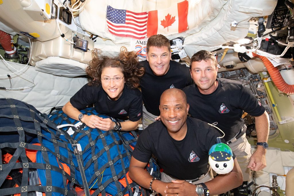 Photo provided by NASA from the Artemis II mission featuring the astronauts smiling inside the space craft.