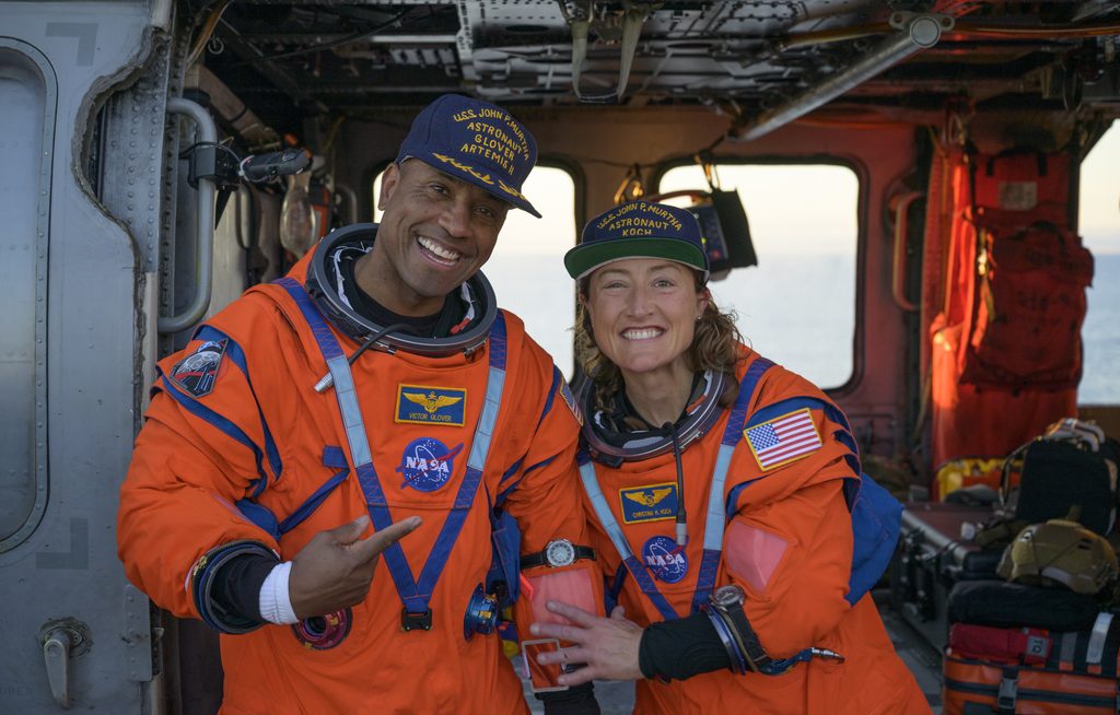 Captain Victor Glover with fellow Artemis II astronaut Christina Koch after splashdown and recovery.